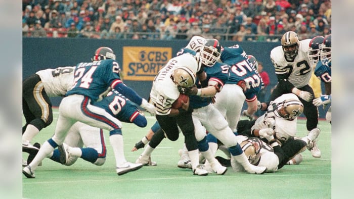 Former New Orleans Saints RB Earl Campbell (35) is stopped by Giants LB Lawrence Taylor during a 1985 game. Credit: Giants.com